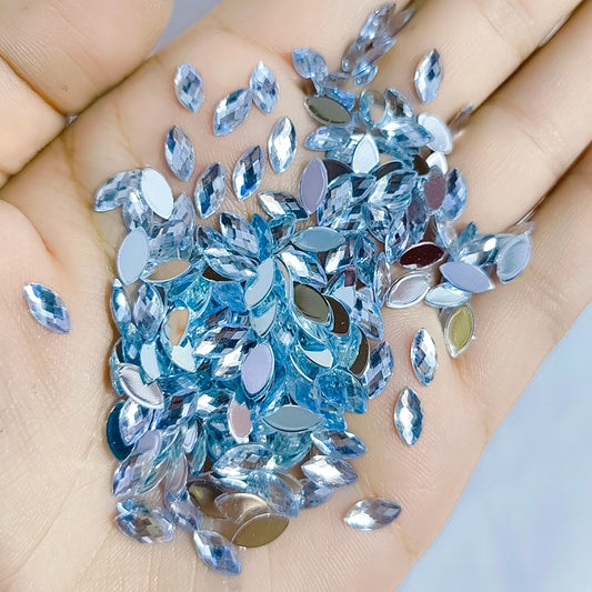 5x10mm (approx. 13/64" x 7/16") acrylic rhinestones feature a faceted navette (horse eye) shape and a flat back for easy glue-on or self-adhesive application