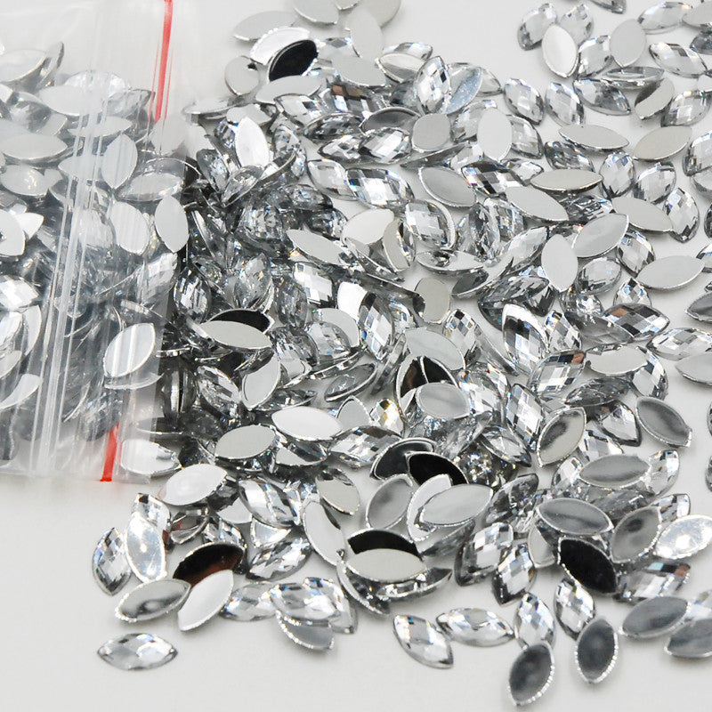 5x10mm (approx. 13/64" x 7/16") acrylic rhinestones feature a faceted navette (horse eye) shape and a flat back for easy glue-on or self-adhesive application
